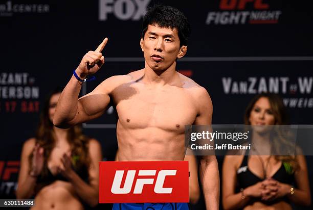 Takeya Mizugaki of Japan poses on the scale during the UFC Fight Night weigh-in inside the Golden 1 Center Arena on December 16, 2016 in Sacramento,...