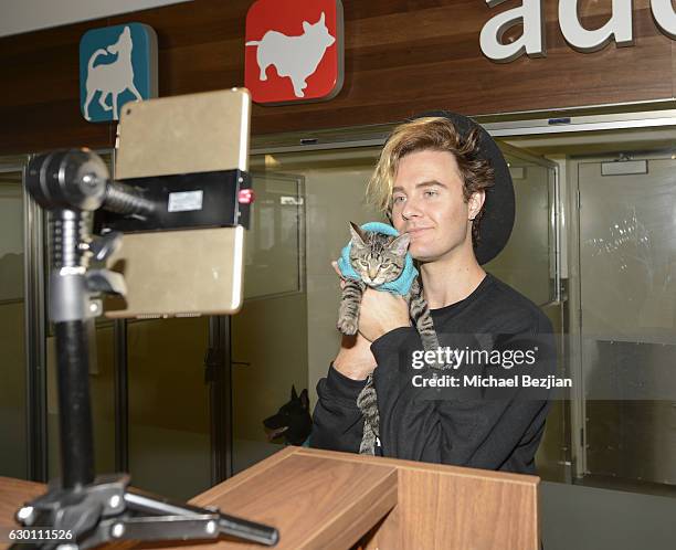 YouTube Personality Bart Baker poses with adoptable cat at Michelson Found Animals Celebrates National Ugly Christmas Sweater Day at Adopt & Shop on...