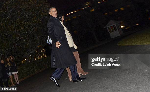 President Obama and daughter Sasha walk toward Marine One, where the Obama family will leave for Hawaii, at The White House on December 16, 2016 in...