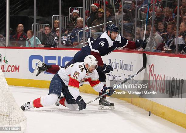 Jakub Kindl of the Florida Panthers fights for the puck against Blake Comeau of the Colorado Avalanche at the Pepsi Center on December 16, 2016 in...