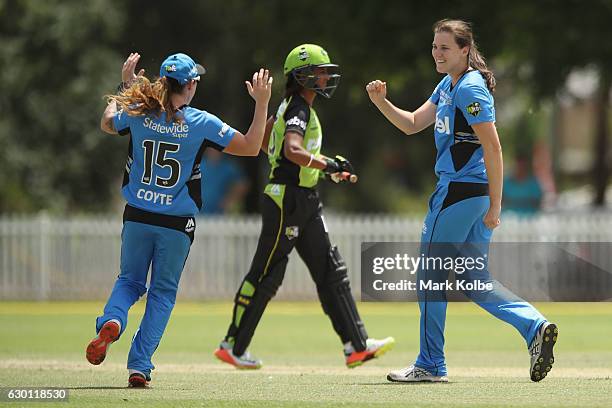 Sarah Coyte and Tahlia McGrath of the Strikers celebrate McGrath taking the wicket of Claire Koski of the Thunder during the WBBL match between the...