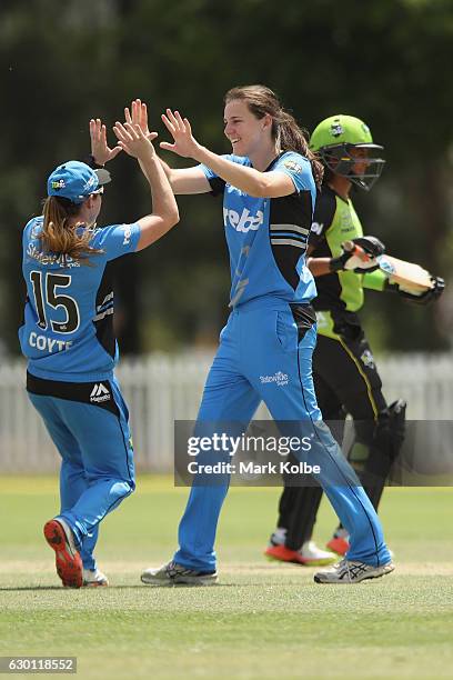 Sarah Coyte and Tahlia McGrath of the Strikers celebrate McGrath taking the wicket of Claire Koski of the Thunder during the WBBL match between the...