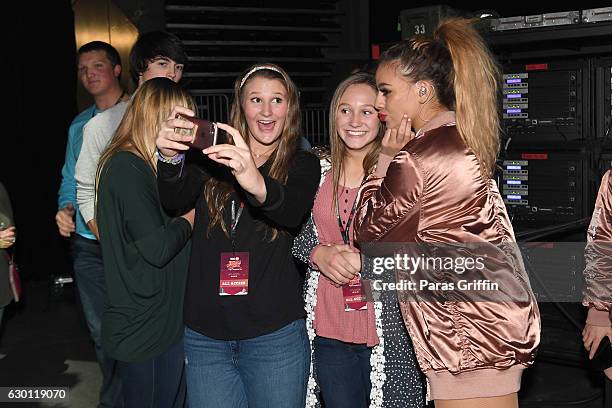 Dinah Jane Hansen of Fifth Harmony poses with fans backstage during Power 96.1's Jingle Ball 2016 at Philips Arena on December 16, 2016 in Atlanta,...