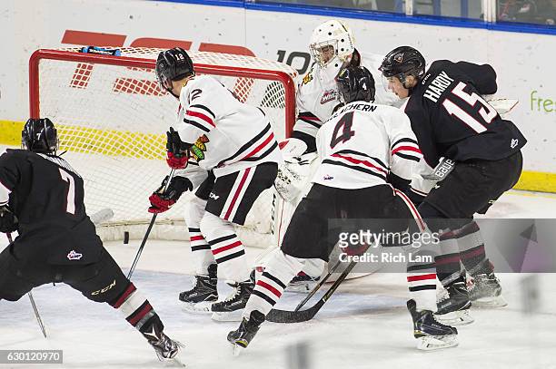Owen Hardy of the Vancouver Giants slide the puck in the net after goalie Cole Kehler of the Portland Winterhawks got trapped behind his net during...