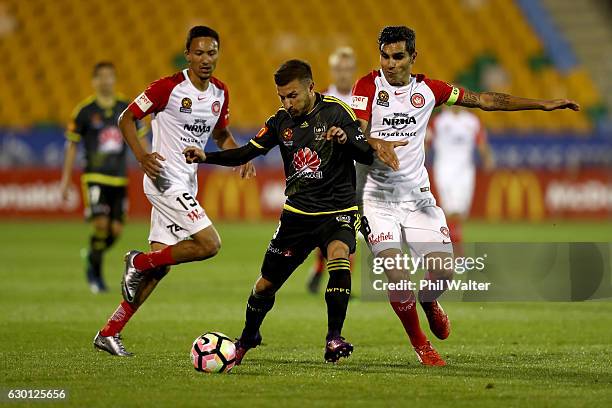 Kosta Barbarrouses of Wellington is tackled by Jaushua Sotirio of Western Sydney during the round 11 A-League match between Wellington and Western...