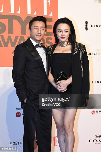 Chinese boxer Zou Shiming and his wife Ran Yingying arrive at the red carpet of 2016 ELLE Style Awards ceremony on December 16, 2016 in Shanghai,...