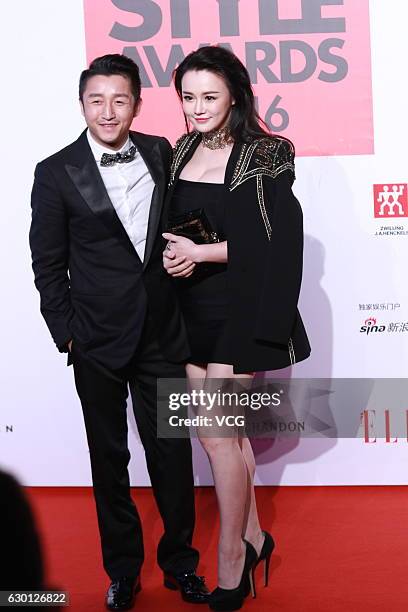 Chinese boxer Zou Shiming and his wife Ran Yingying arrive at the red carpet of 2016 ELLE Style Awards ceremony on December 16, 2016 in Shanghai,...