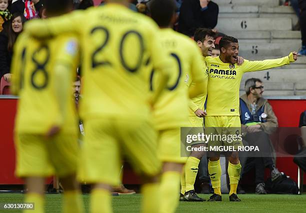 Villarreal's Mexican forward Jonathan dos Santos celebrates with teammates after scoring a goal during the Spanish league football match Real...