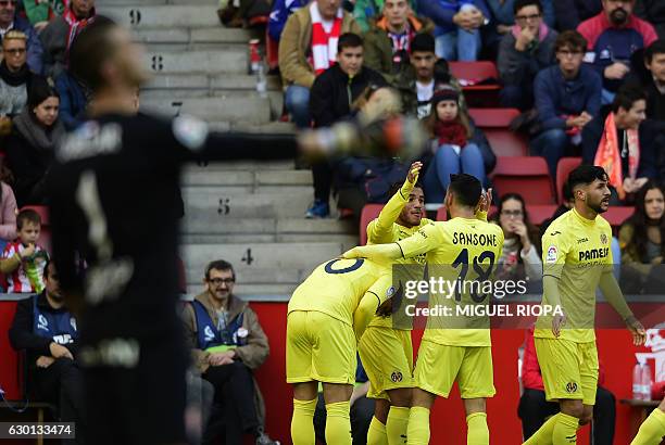 Villarreal's Mexican forward Jonathan dos Santos celebrates with teammates after scoring the opening goal during the Spanish league football match...