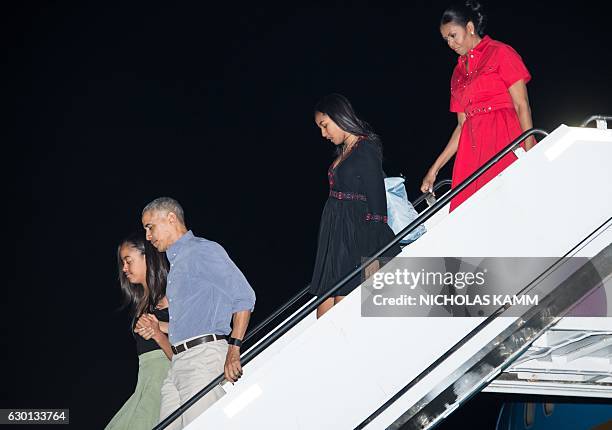 President Barack Obama, First Lady Michelle Obama and daughters Sasha and Malia arrive at Joint Base Pearl Harbor-Hickam in Honolulu on December 16,...