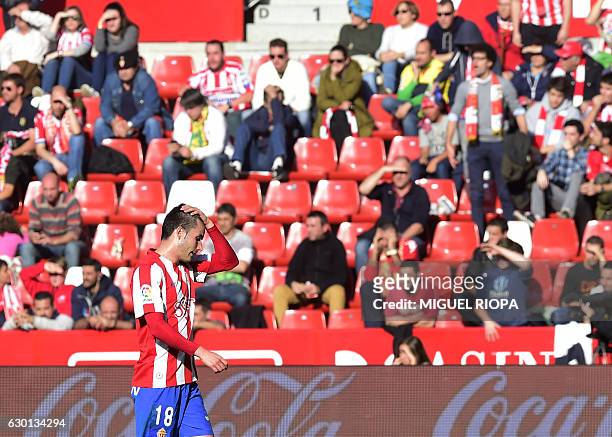 Sporting Gijon's forward Ismael Lopez gestures after Villarreal's third goal during the Spanish league football match Real Sporting de Gijon vs...