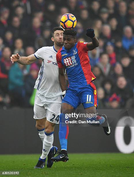 Gary Cahill of Chelsea and Wilfried Zaha of Crystal Palace battle to win a header during the Premier League match between Crystal Palace and Chelsea...