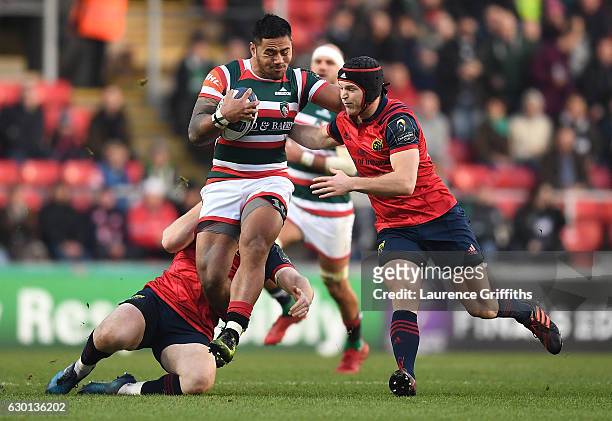 Manu Tuilagi of Leicester Tigers is tackled by Tyler Bleyendaal of Munster during the European Rugby Champions Cup match between Leicester Tigers and...