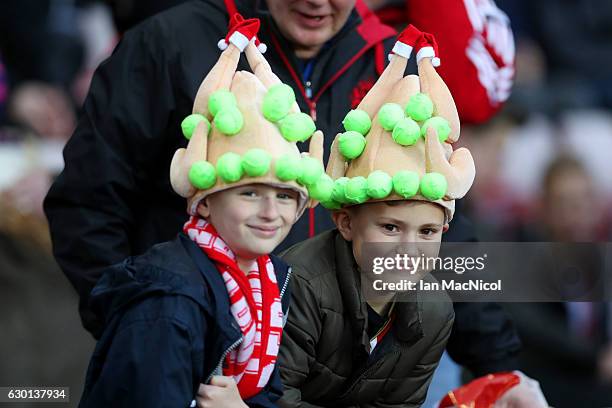 Two fans get in the festive mood with some Christmas turkey hats during the Premier League match between Sunderland and Watford at Stadium of Light...