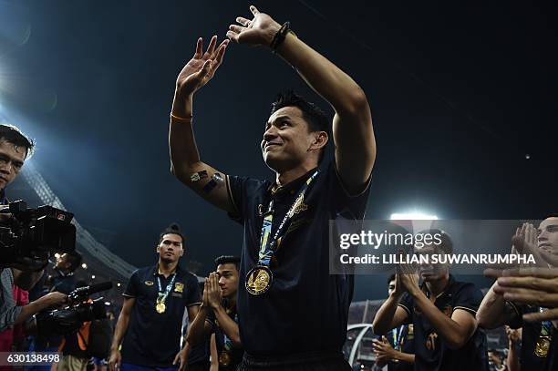 Thailand football manager Kiatisuk Senamuang celebrates with his team after winning the AFF Suzuki Cup Final between Thailand and Indonesia at...