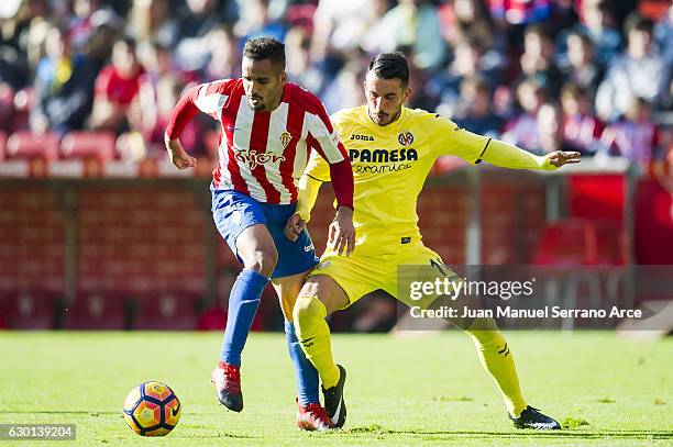 Nicola Sansone of Villarreal CF duels for the ball with Douglas Pereira of Real Sporting de Gijon during the La Liga match between Real Sporting de...