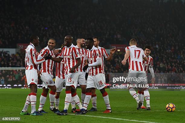 Stoke players mob Stoke City's Welsh midfielder Joe Allen after he scored his team's second goal during the English Premier League football match...