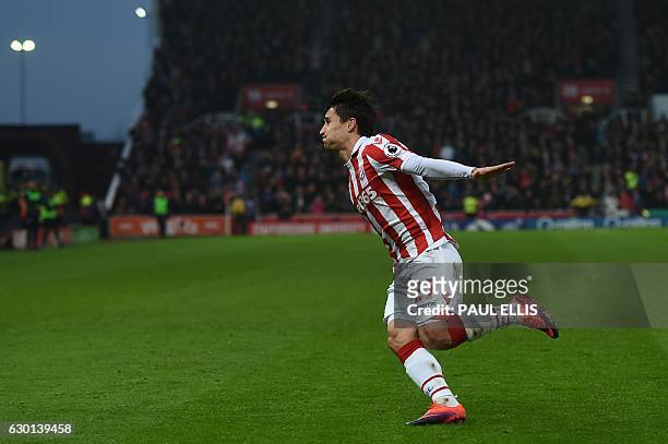 Stoke City's Spanish striker Bojan Krkic celebrates scoring his team's first goal from the penalty spot during the English Premier League football...