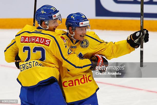 Players of Sweden celebrates with his teammates after scoring during the Euro Hockey tour Channel One Cup match between Finland and Sweden at the VTB...