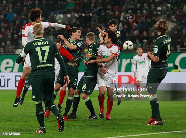 Martin Hinteregger of Augsburg scores a goal during the Bundesliga match between FC Augsburg and Borussia Moenchengladbach at WWK Arena on December...