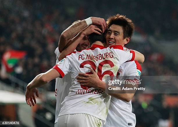 Martin Hinteregger of Augsburg celebrates with Koo Ja-Cheol after scoring a goal during the Bundesliga match between FC Augsburg and Borussia...