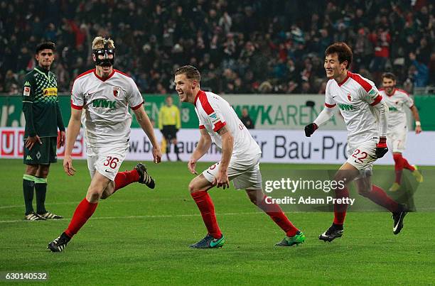 Martin Hinteregger of Augsburg celebrates with Jeffrey Gouweleeuw after scoring a goal during the Bundesliga match between FC Augsburg and Borussia...