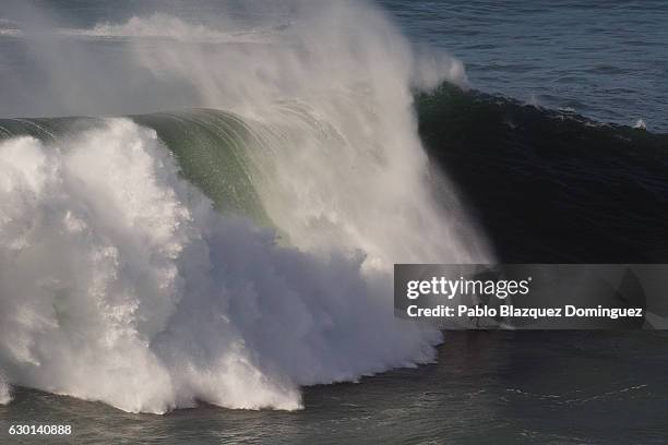 Brazilian surfer Marcelo Luna rides a big wave at Praia do Norte on December 17, 2016 in Nazare, Portugal. Nazare's giant waves are increasingly...