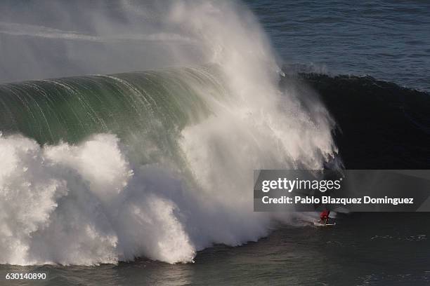 Brazilian surfer Marcelo Luna rides a big wave at Praia do Norte on December 17, 2016 in Nazare, Portugal. Nazare's giant waves are increasingly...