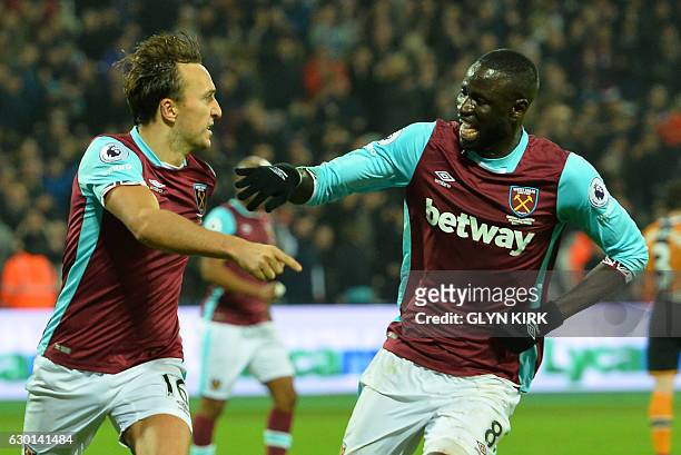 West Ham United's English midfielder Mark Noble celebrates with West Ham United's Senegalese midfielder Cheikhou Kouyate after scoring the opening...