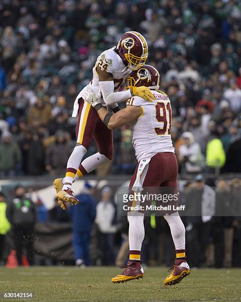Ryan Kerrigan and Josh Norman of the Washington Redskins celebrate in the final moments of the game against the Philadelphia Eagles at Lincoln...