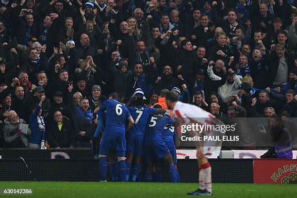 Leicester players mob Leicester City's Ghanaian midfielder Daniel Amartey after he scored his team's second goal during the English Premier League...