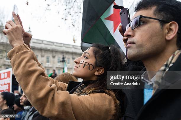 People attend a rally in solidarity with Syria calling for current support of resolutions for the horrific situation in Aleppo in London, United...