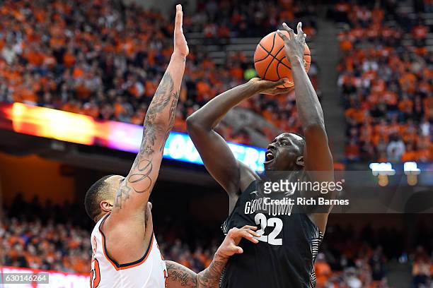 Akoy Agau of the Georgetown Hoyas shoots the ball against the defense of DaJuan Coleman of the Syracuse Orange during the first half at the Carrier...