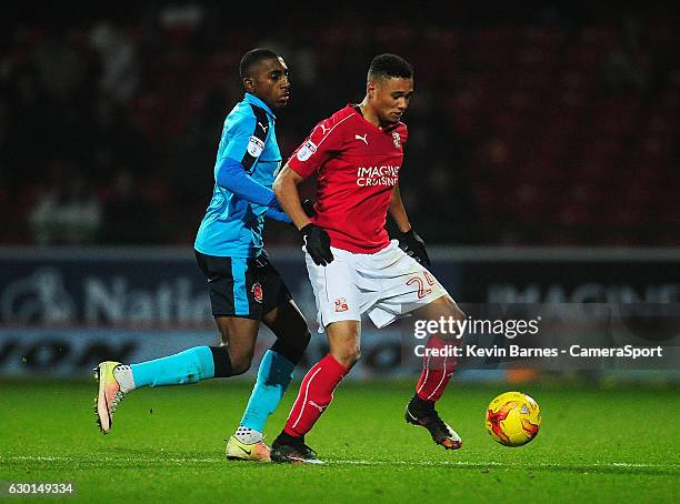 Swindon Town's Jermaine Hylton under pressure from Fleetwood Town's Amari'i Bell during the Sky Bet League One match between Swindon Town and...