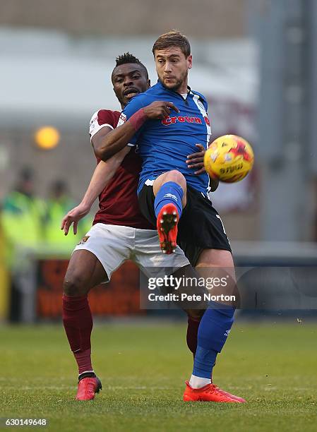 Gabriel Zakuani of Northampton Town contests the ball with Steven Davies of Rochdale during the Sky Bet League One match between Northampton Town and...