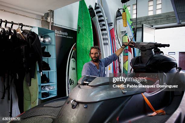 Portuguese surfer Hugo Vau does the maintenance of his jet ski after a big wave session on December 17, 2016 in Nazare, Portugal. Nazare's giant...