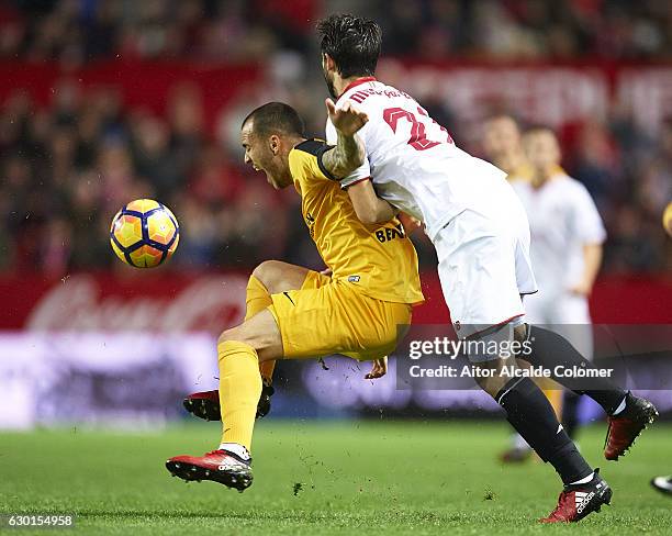 Sandro Ramirez of Malaga CF being fouled by Nicolas Pareja of Sevilla FC during the La Liga match between Sevilla FC and Malaga CF at Estadio Ramon...