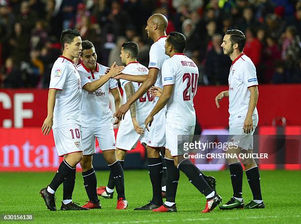 Sevilla's French forward Wissam Ben Yedder celebrates a goal with teammates during the Spanish league football match Sevilla FC vs Malaga CF at the...