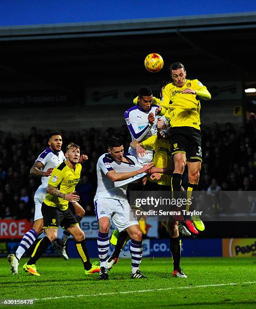 Isaac Hayden of Newcastle United and Ciaran Clark jostle with Jackson Irvine of Burton Albion and John Mousinho to win a header in the box during the...