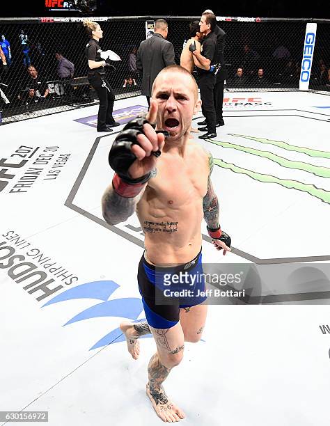 Eddie Wineland celebrates his victory over Takeya Mizugaki of Japan in their bantamweight bout during the UFC Fight Night event inside the Golden 1...
