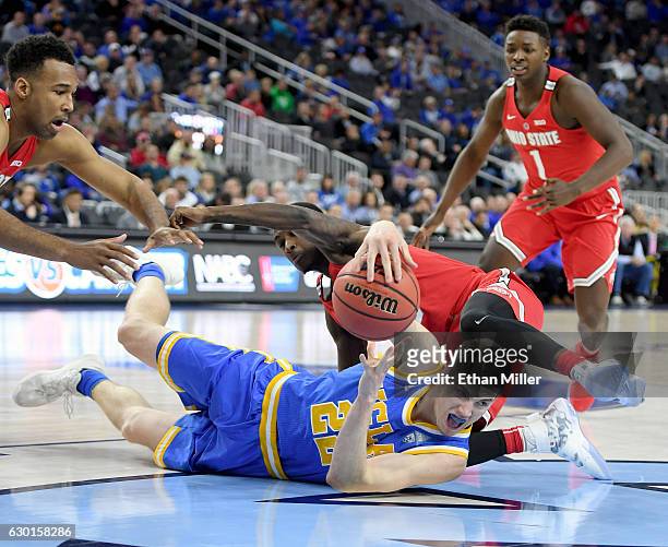 Leaf of the UCLA Bruins passes from the floor in front of Kam Williams of the Ohio State Buckeyes during the CBS Sports Classic at T-Mobile Arena on...