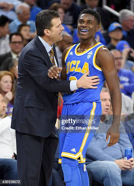 Head coach Steve Alford of the UCLA Bruins talks with Aaron Holiday during their game against the Ohio State Buckeyes during the CBS Sports Classic...