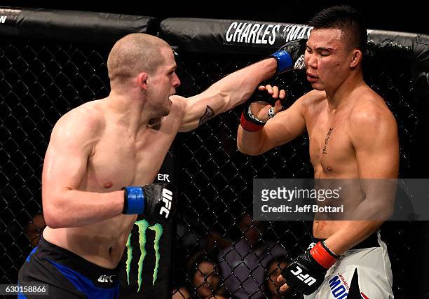 Alex Morono punches James Moontasri in their welterweight bout during the UFC Fight Night event inside the Golden 1 Center Arena on December 17, 2016...