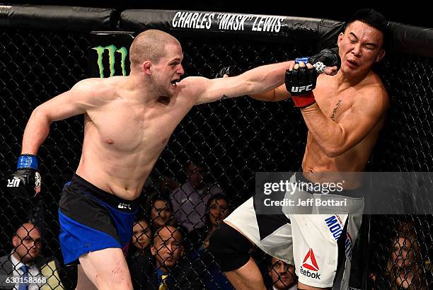 Alex Morono punches James Moontasri in their welterweight bout during the UFC Fight Night event inside the Golden 1 Center Arena on December 17, 2016...