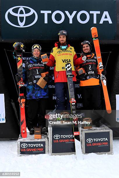 Benoit Valentin of France in second place, Kevin Rolland of France in first place, and Aaron Blunck in third place celebrate on the podium during the...