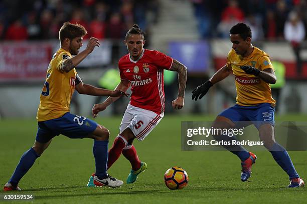 Estoril's midfielder Diogo Amado from Portugal and Estoril's defender Ailton Silva from Brazil tries to stop Benfica's midfielder Ljubomir Fejsa from...
