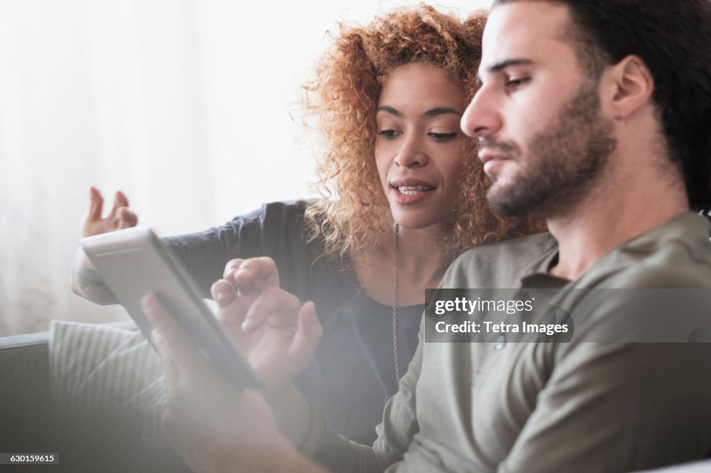 Young couple using tablet.