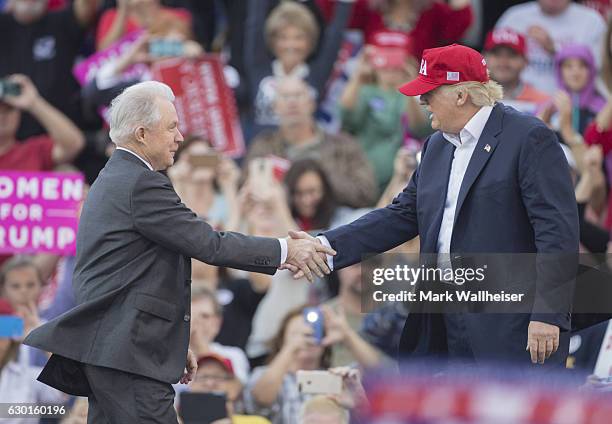 President-elect Donald Trump greets Senator Jeff Sessions, Trump's picks for attorney general, during a thank you rally in Ladd-Peebles Stadium on...