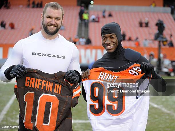 Defensive end Margus Hunt of the Cincinnati Bengals and quarterback Robert Griffin III of the Cleveland Browns pose for a picture as they exchange...