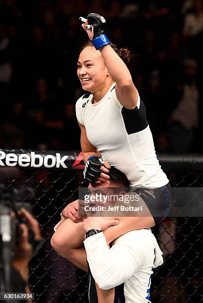 Michelle Waterson celebrates after her submission victory over Paige VanZant in their women's strawweight bout during the UFC Fight Night event...